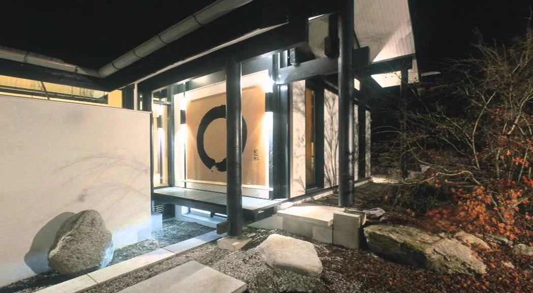 Villa im Park: Videostandbild, Eingangshof mit Findling und Kalligrafie-Wand bei Nacht
